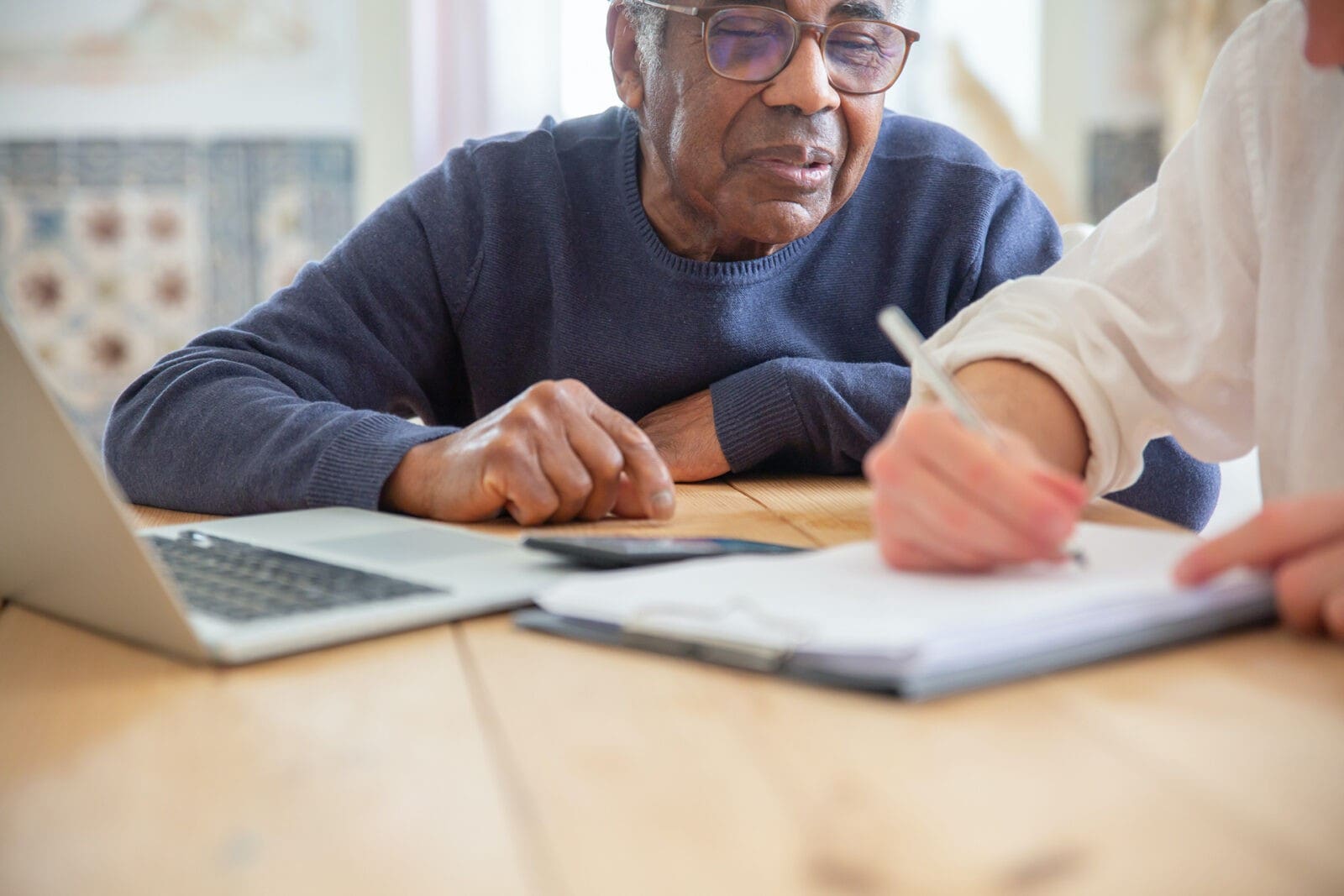 two people looking over paperwork at table