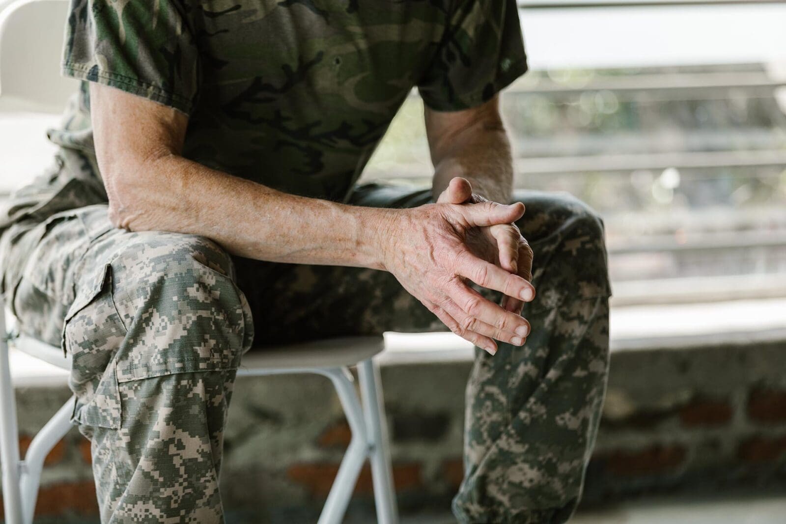 person sitting on chair in military uniform