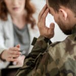 Stressed veteran speaks with a consultant