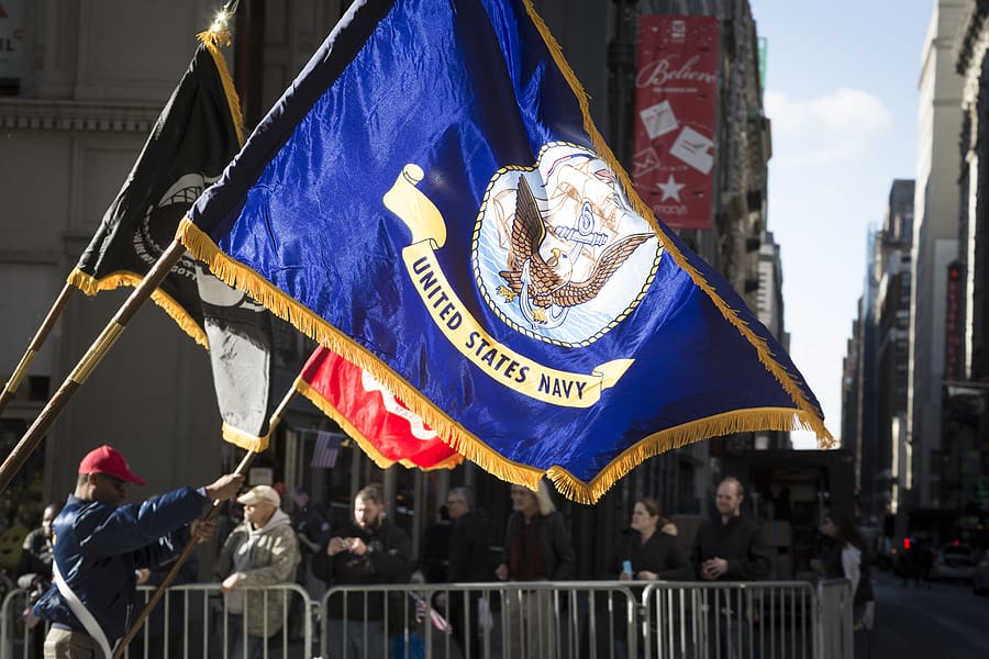 US Navy flag held by veterans eligible for VA benefits