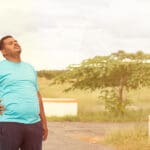 Young overweight veteran taking a break while jogging