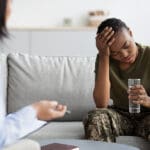 Female military veteran speaking with a therapist after surviving a sexual assault