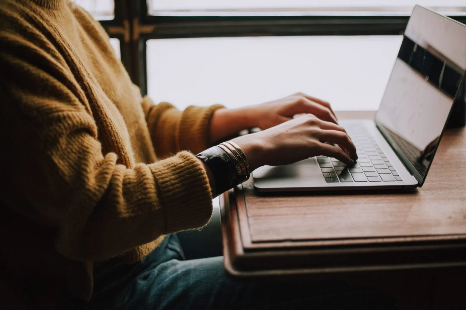 Woman typing on a laptop