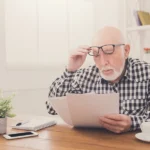 Confused veteran looking at paperwork from the VA about his disability claim