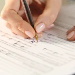 Female veteran filling out paperwork for a VA disability claim