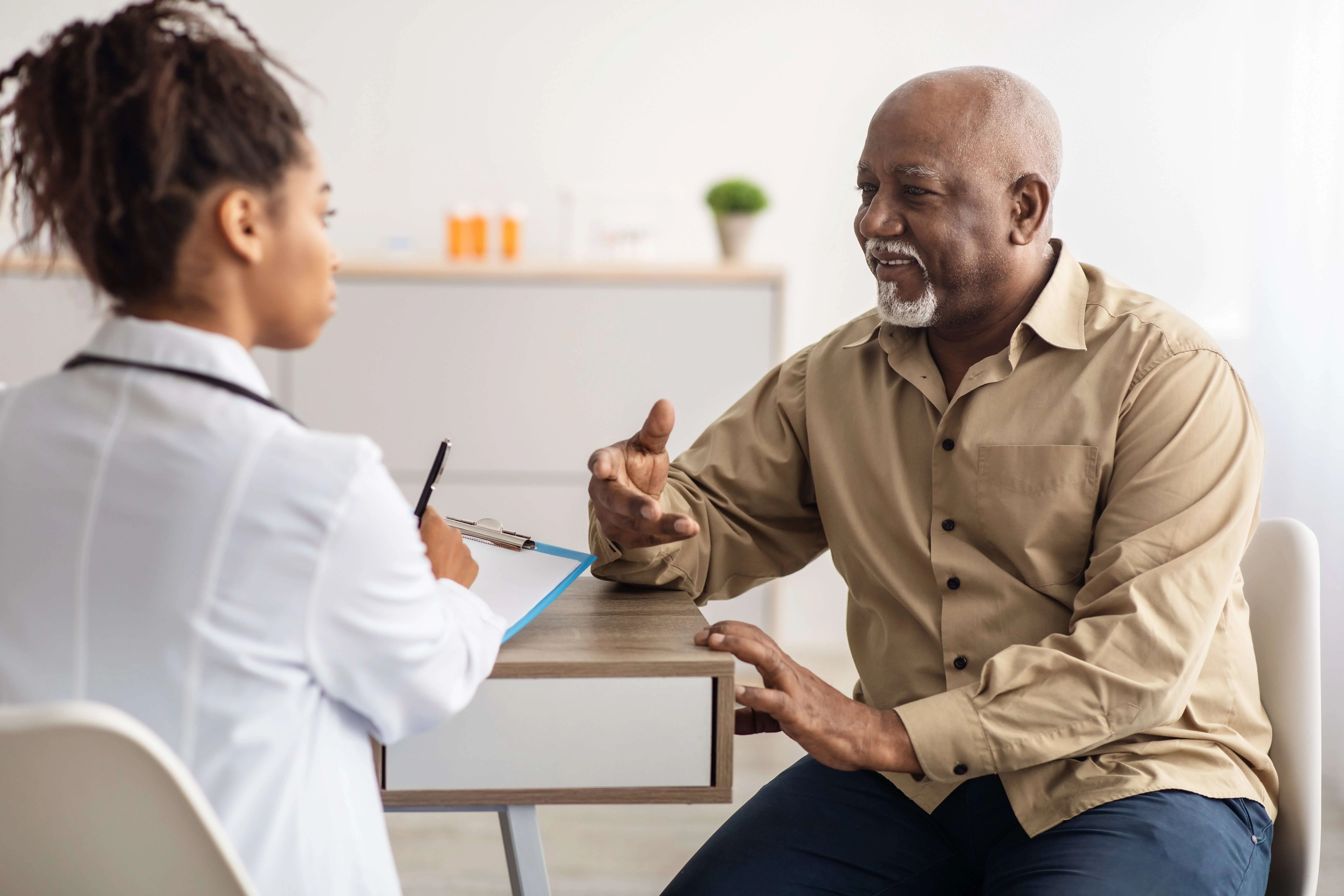 older veteran discusses his service related disability with a VA doctor