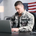 Male veteran researching whether his disability qualifies as a PACT Act presumptive condition on his laptop