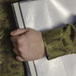 veteran in uniform holding his military service records in a folder
