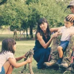 veteran with a 100% va disability rating and dependent spouse and children playing with his family in park